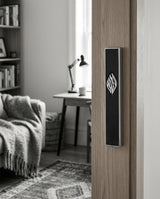 Black concrete Aesh Sheli mezuzah mounted on an interior door frame, lifestyle photo, Kameart