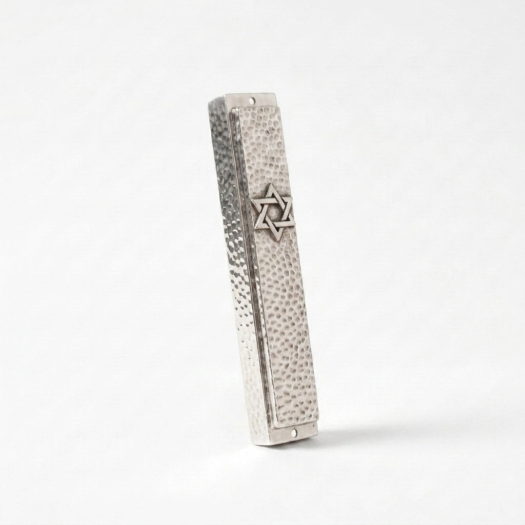 Hammered silver mezuzah case with Star of David, three-quarter angle view showing texture depth, handmade in Israel, Kameart