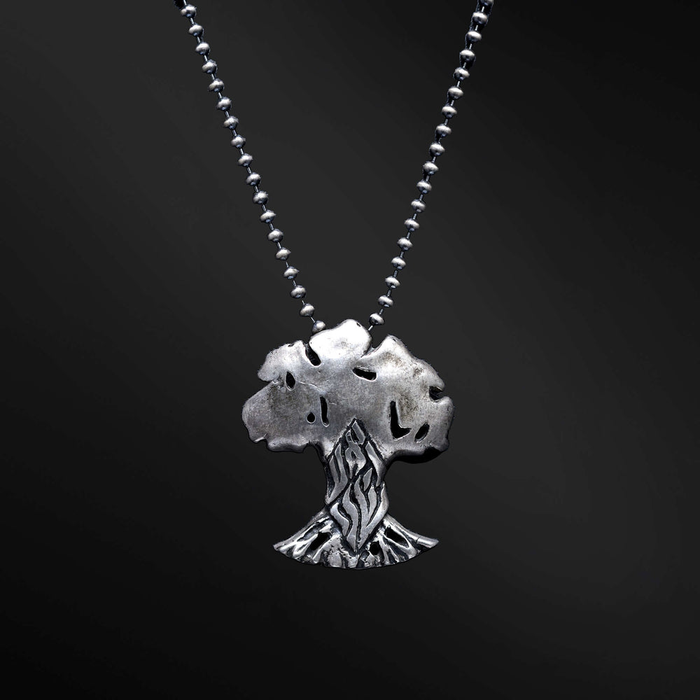 "HaEts Cheli Necklace: A photograph showcasing the exquisite HaEts Cheli necklace. The pendant features a captivating tree design with the Hebrew phrase 'HaEsh Cheli' delicately engraved. The photo captures the beauty of the necklace's intricate details, highlighting its symbolic representation of rootedness, strength, and the connection to nature."
