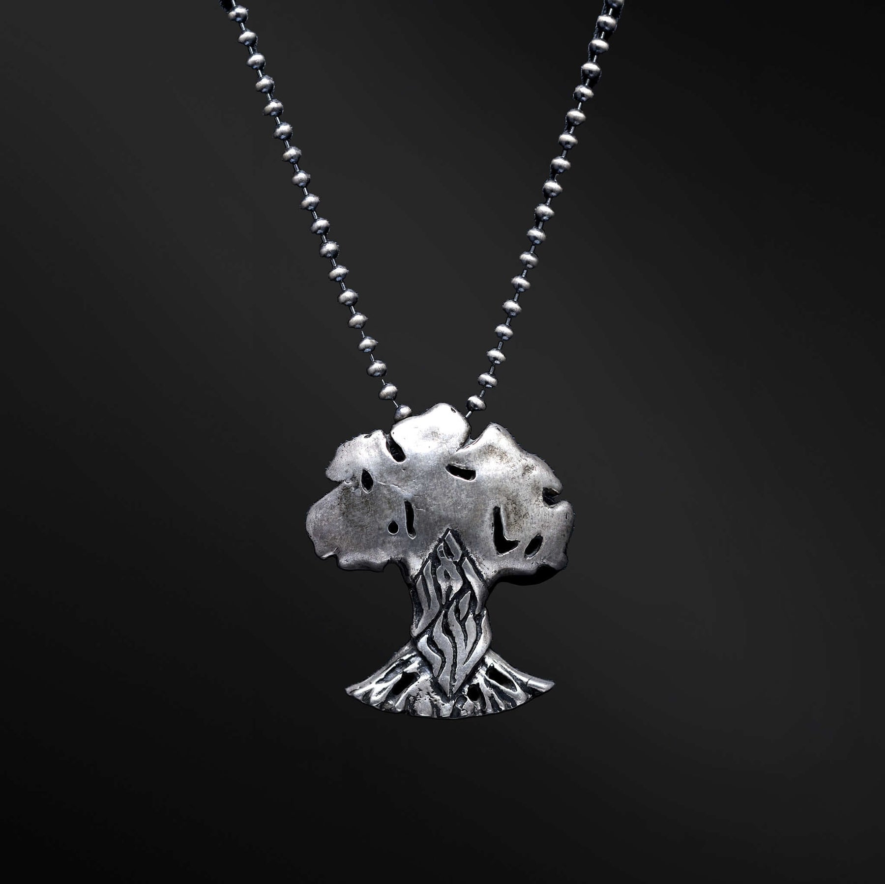 "HaEts Cheli Necklace: A photograph showcasing the exquisite HaEts Cheli necklace. The pendant features a captivating tree design with the Hebrew phrase 'HaEsh Cheli' delicately engraved. The photo captures the beauty of the necklace's intricate details, highlighting its symbolic representation of rootedness, strength, and the connection to nature."