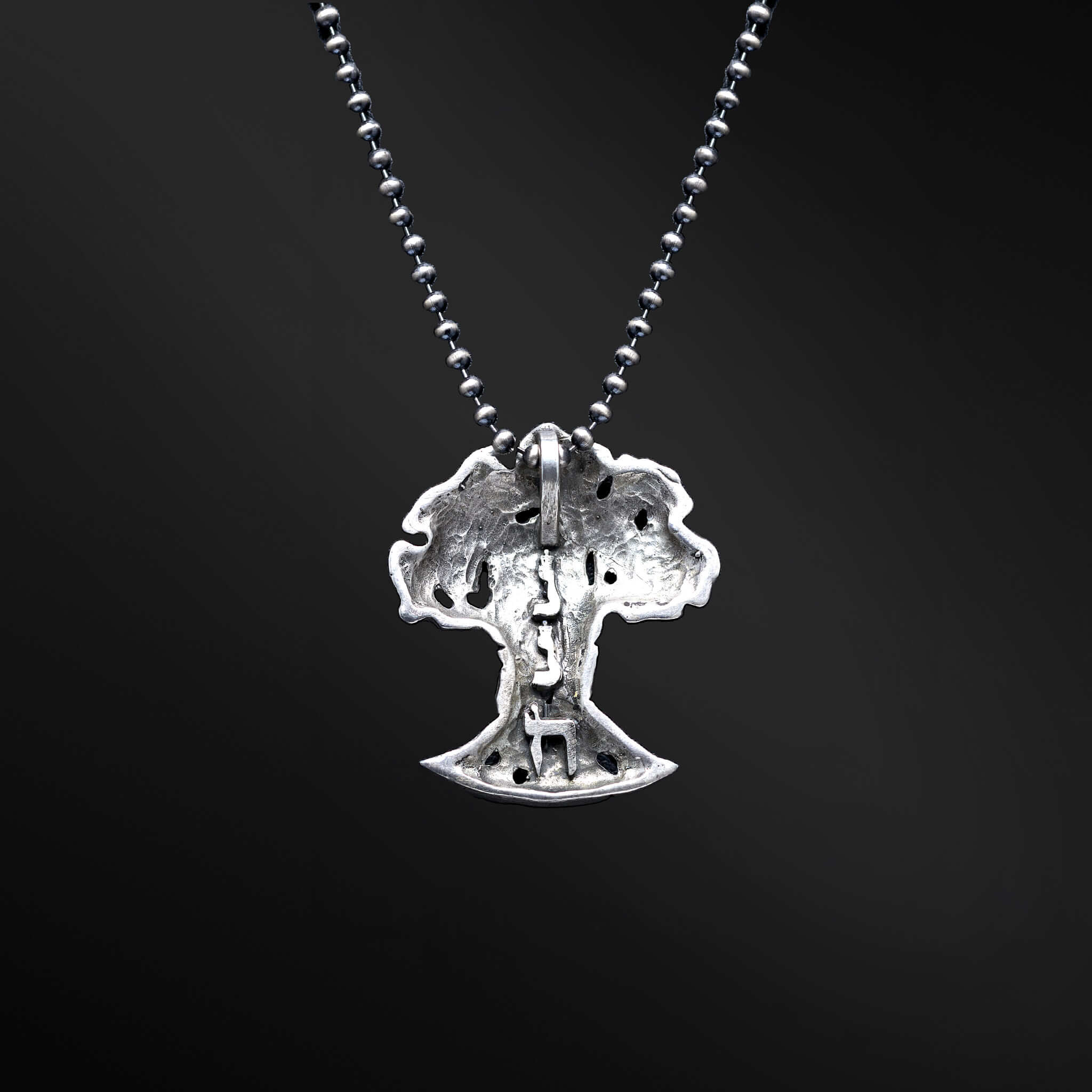 &quot;HaEts Cheli Necklace: A photograph showcasing the exquisite HaEts Cheli necklace. The pendant features a captivating tree design with the Hebrew phrase &