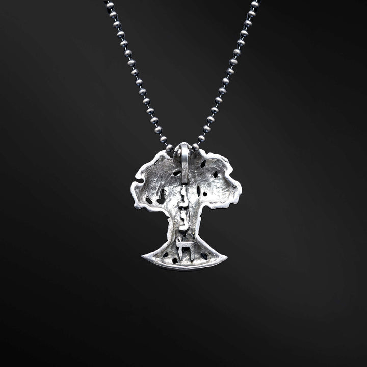 "HaEts Cheli Necklace: A photograph showcasing the exquisite HaEts Cheli necklace. The pendant features a captivating tree design with the Hebrew phrase 'HaEsh Cheli' delicately engraved. The photo captures the beauty of the necklace's intricate details, highlighting its symbolic representation of rootedness, strength, and the connection to nature."