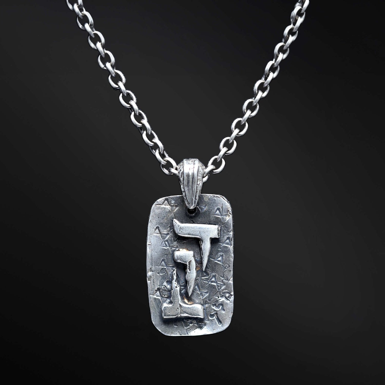 &quot;David Necklace: A captivating image of our exquisite necklace celebrating the essence of King David. The pendant proudly displays the Hebrew letters for &quot;David&quot; and the iconic Magen David symbol, representing a profound connection to heritage and strength. The photo showcases the intricate details of the necklace, serving as a powerful inspiration of faith and courage.&quot;