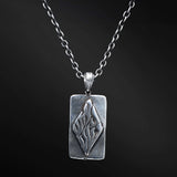 "Elkana Pendant: Unleash the power of your inner flame with the captivating Elkana pendant. Its elegant design showcases the phrase 'Aesh Sheli' engraved on a sleek plaque, representing the fire that resides within. Let its presence serve as a constant reminder of your inner strength, passion, and resilience as you navigate life's journey."