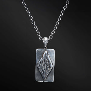"Elkana Pendant: Unleash the power of your inner flame with the captivating Elkana pendant. Its elegant design showcases the phrase 'Aesh Sheli' engraved on a sleek plaque, representing the fire that resides within. Let its presence serve as a constant reminder of your inner strength, passion, and resilience as you navigate life's journey."