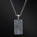 "Elkana Pendant: Unleash the power of your inner flame with the captivating Elkana pendant. Its elegant design showcases the phrase 'Aesh Sheli' engraved on a sleek plaque, representing the fire that resides within. Let its presence serve as a constant reminder of your inner strength, passion, and resilience as you navigate life's journey."
