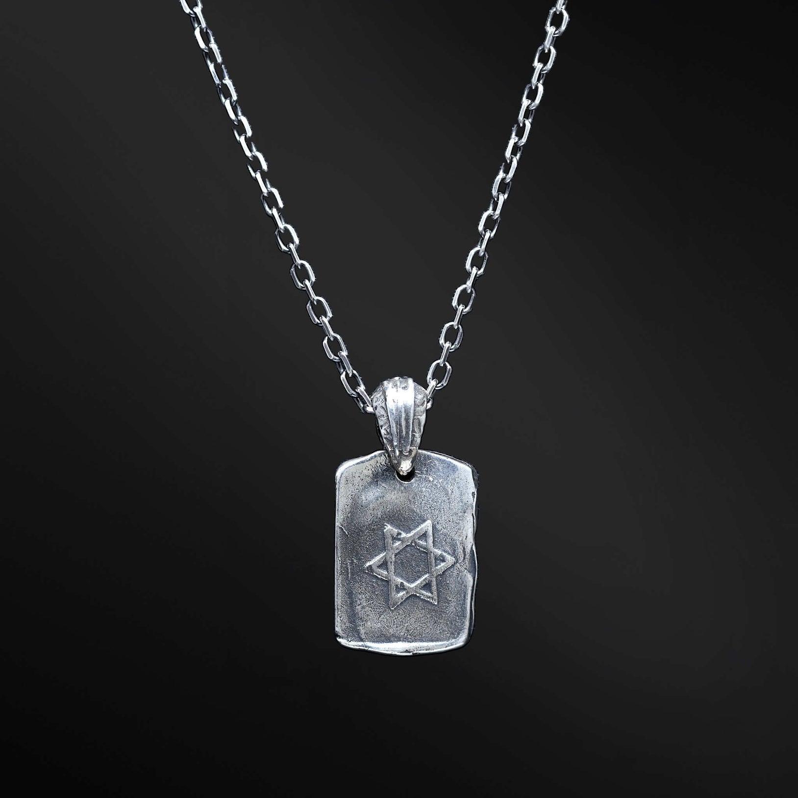 Channel luck and protection with our He necklace, finely crafted in sterling silver. This rectangular pendant showcases the Hebrew letter "ה," symbolizing the divine presence. Its reversible design and concealed Magen David on the back make it a truly remarkable talisman of blessings and spiritual connection.