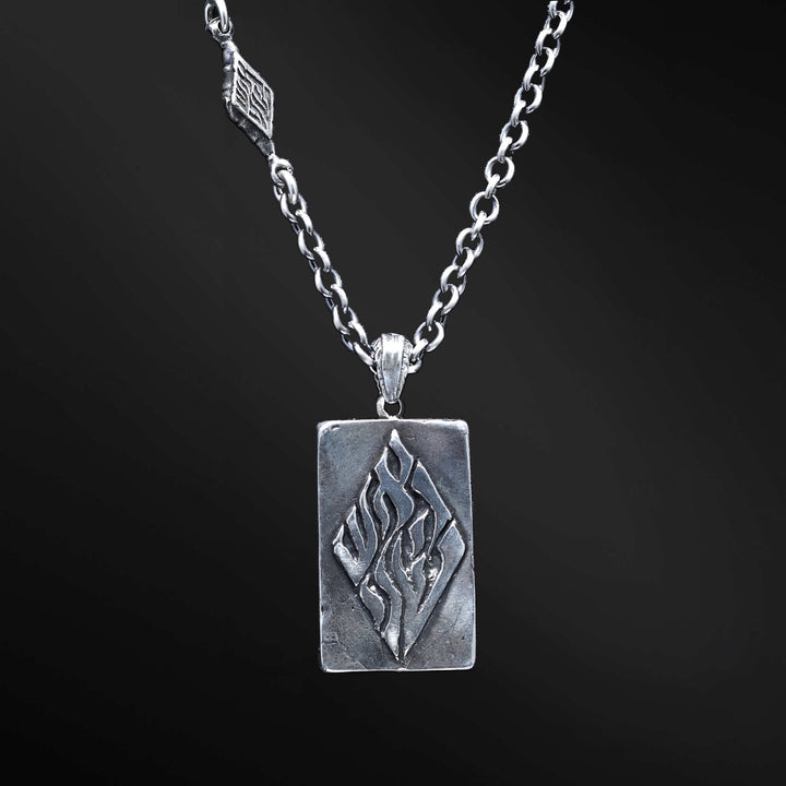 "Hidai Pendant: A collection of captivating images showcasing the fiery essence of the Hidai pendant. Engraved with the empowering words 'Aesh Sheli' (My Fire), it serves as a catalyst for passion and confidence. The precision craftsmanship of the square pendant radiates elegance and uniqueness, symbolizing your own distinct journey. Let these photos ignite your inner flame and empower you to shine boldly, embracing your true essence."