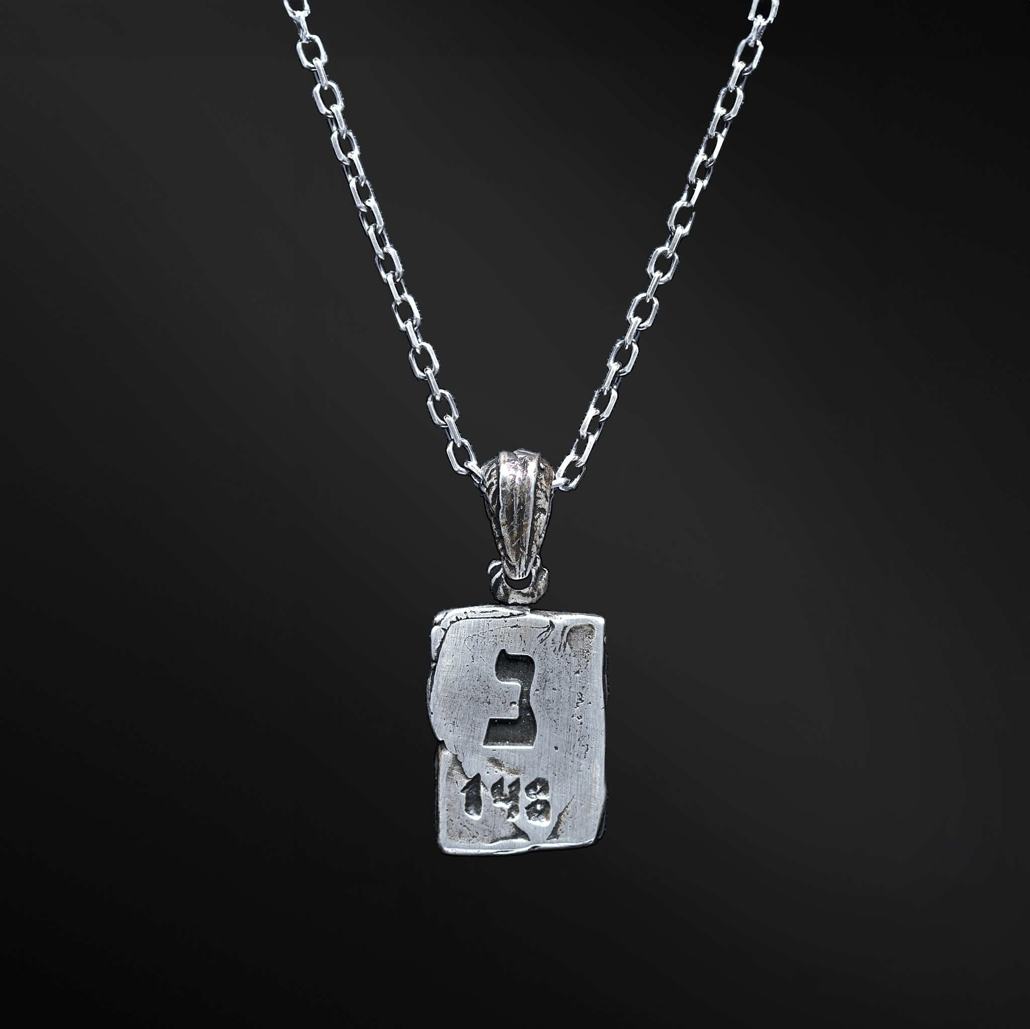 Unlock the hidden meaning of our Noun necklace. Crafted with a rectangular silver plate showcasing the Hebrew letter &quot;נ&quot; and the number 148, this pendant holds a special significance and becomes a beautiful expression of spirituality. Choose this piece to elevate your personal style with a touch of depth and profound meaning.