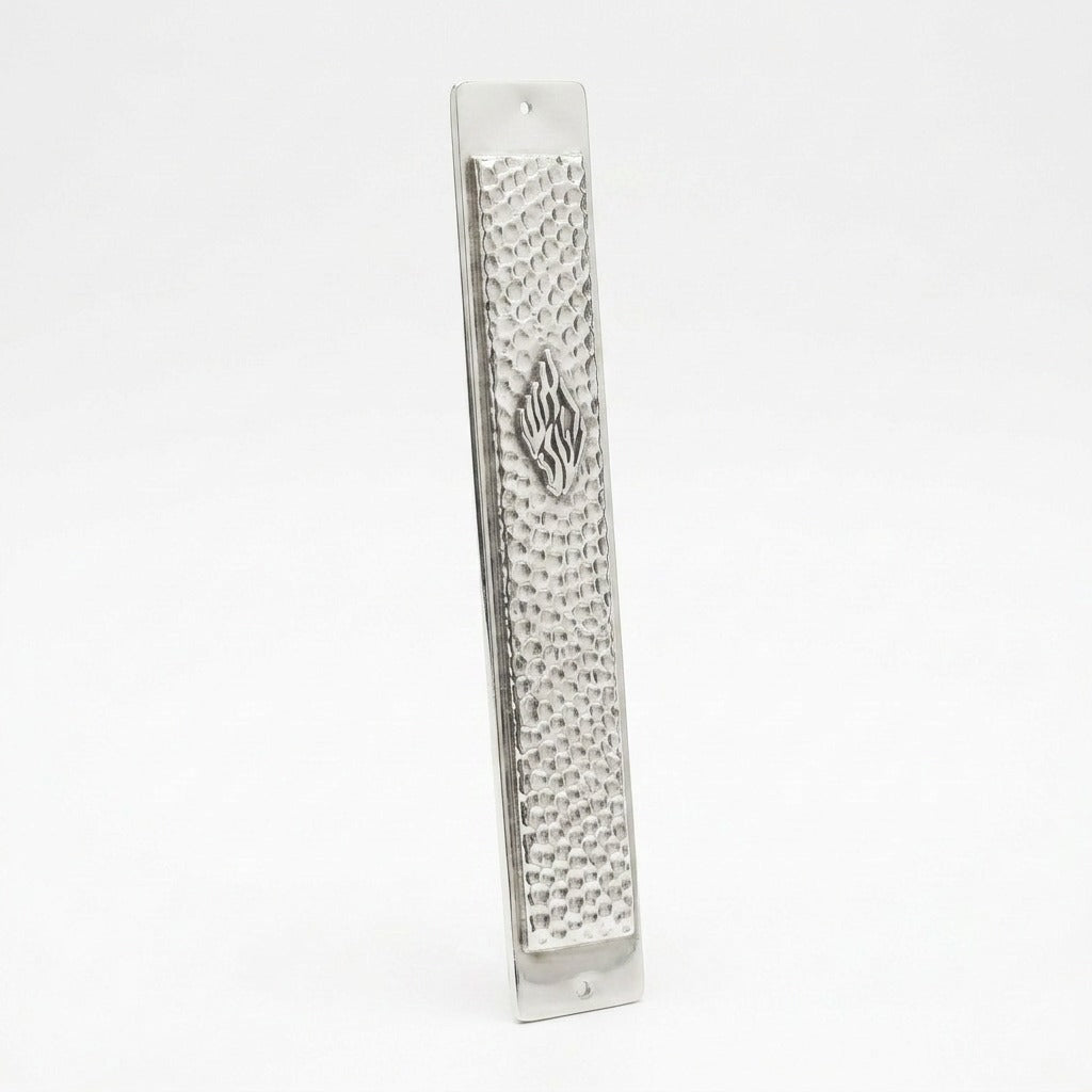 Hammered silver mezuzah plaque with Aesh Sheli flame emblem, angled view showing texture and thickness, handmade in Israel, Kameart