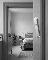 Hammered silver Aesh Sheli mezuzah mounted on an interior door frame, lifestyle photo, Kameart
