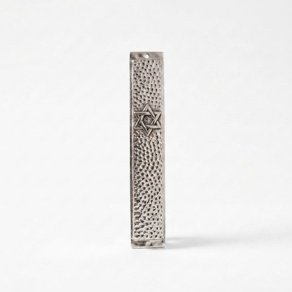 Close-up of hammered silver mezuzah case with engraved Star of David detail, handmade in Israel, Kameart