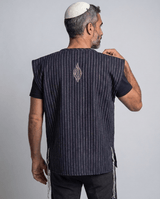 Man wearing tallit katan blue stripes, back view showing the Aesh Sheli flame embroidery, Kameart
