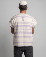 Man wearing tallit katan in purple stripes, back view showing the Aesh Sheli flame embroidery, Kameart