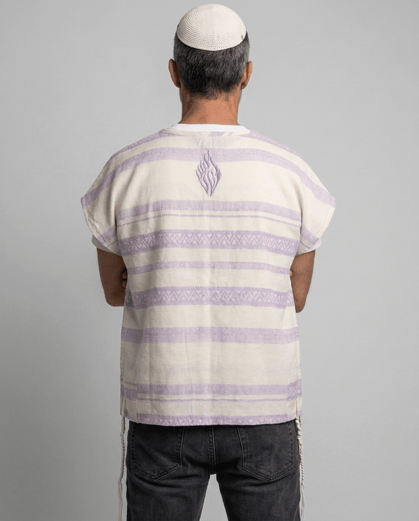 Man wearing tallit katan in purple stripes, back view showing the Aesh Sheli flame embroidery, Kameart